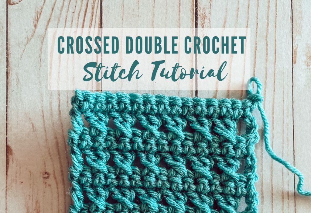 A crochet swatch of the Crossed Double Crochet Stitch in blue yarn is laid on a wood background. Text reads "Crossed Double Crochet Stitch Tutorial"
