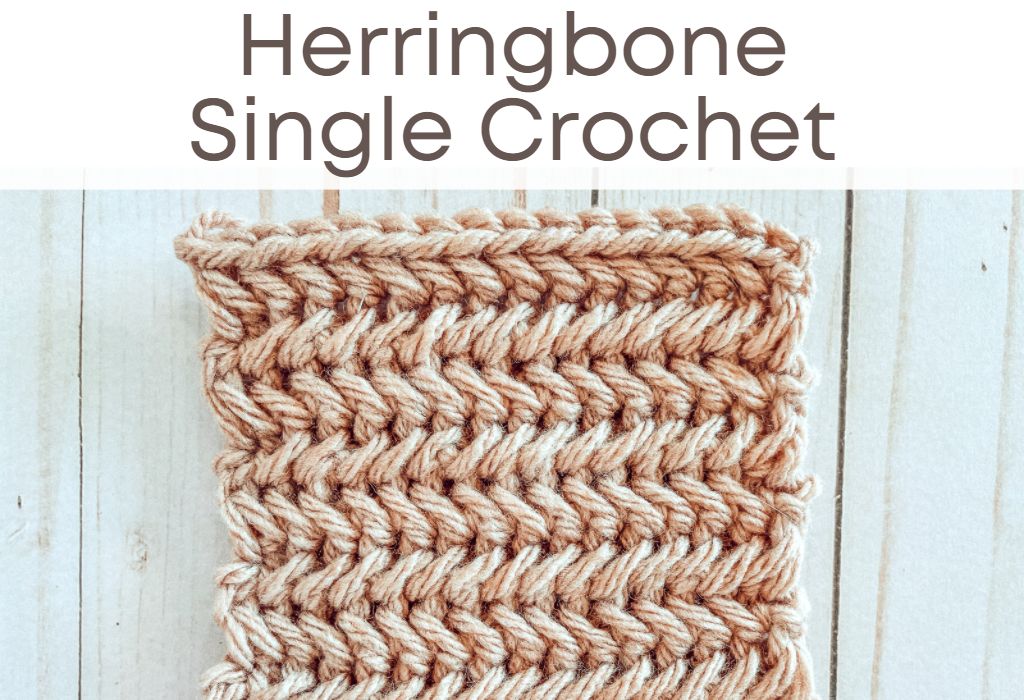 A crochet swatch of the Herringbone Single Crochet stitch in beige yarn is on a wood background. Text at the top says "Herringbone Single Crochet"