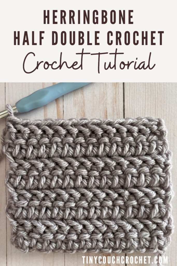 A close up of the Herringbone Half Double Crochet stitch in a swatch made of gray, bulky yarn. Text at the top says "Herringbone Half Double Crochet Crochet Tutorial"