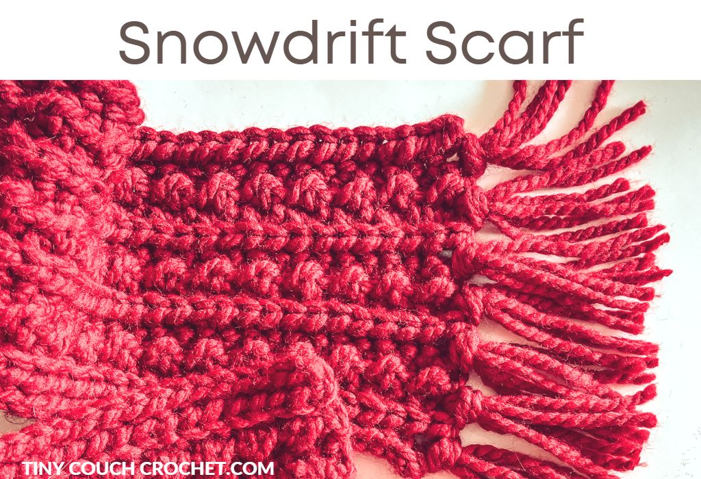 A photo of a chunky crochet scarf with the text "snowdrift scarf"