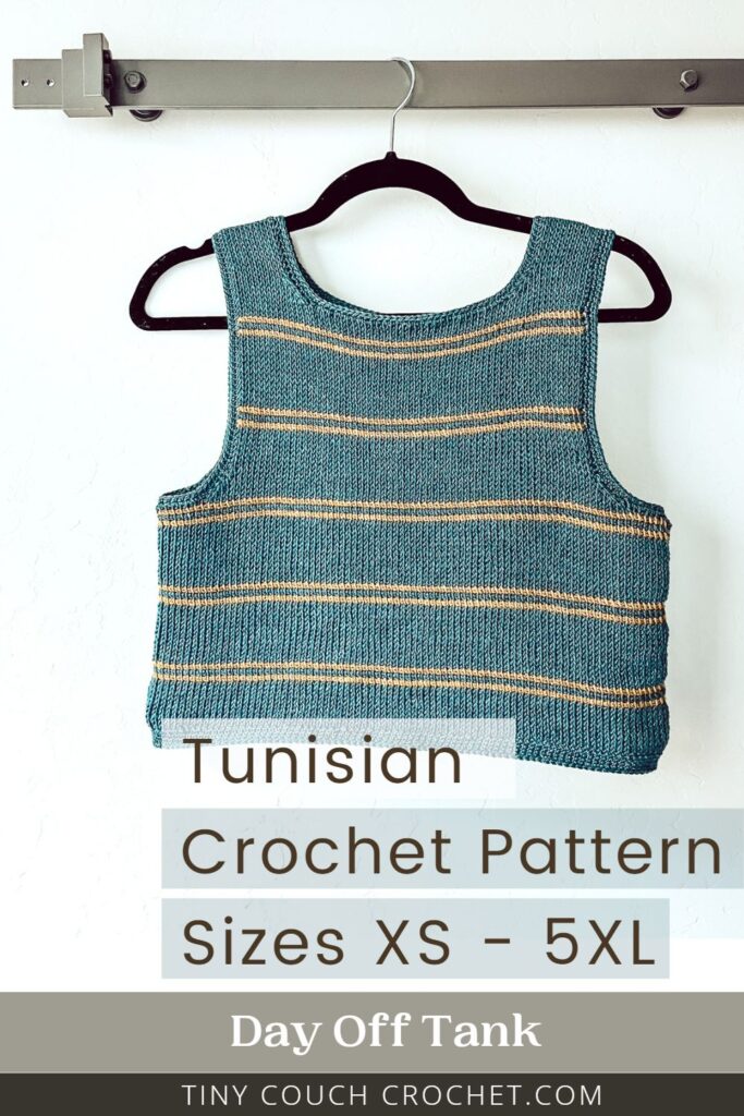 A tunisian crochet tank top is hanging on a wall by a hanger. The top is blue with gold stripes. Text reads "Tunisian Crochet Pattern Sizes XS - 5XL Day Off Tank Tinycouchcrochet.com"